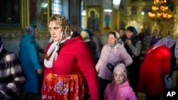 FILE - A woman leaves at the end of a religious service inside the Saint John the Baptist cathedral in Comrat, the capital of Gagauzia, an autonomous part of Moldova, Nov. 2, 2024.