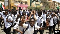 Sudanese students protest in the capital Khartoum on July 30, 2019, a day after teenagers were shot at a rally against shortages of bread and fuel in the town of al-Obeid, southwest of the capital.