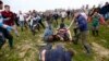 Players fight for the bottle during the bottle-kicking game in Hallaton, central England, April 1, 2013.