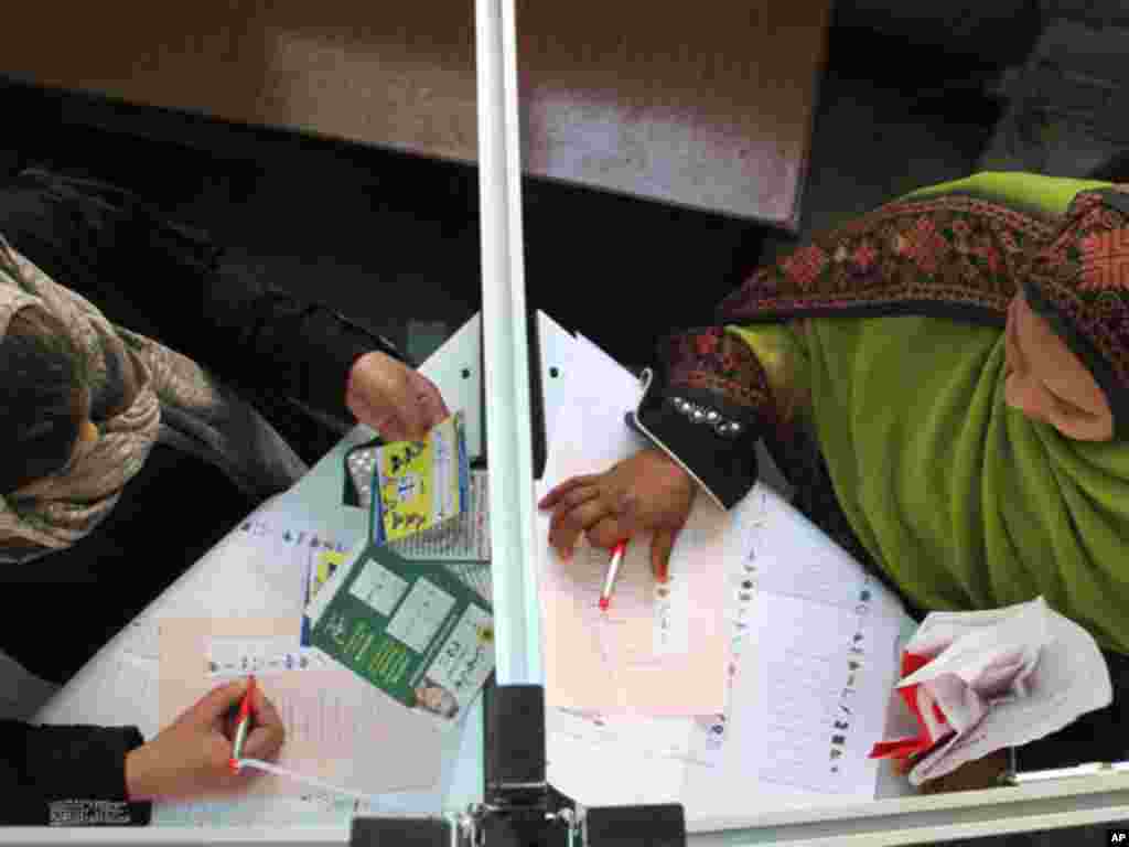 On November 29, 2011, women cast their votes on the second day of parliamentary elections in Cairo, in the first parliamentary elections since the ouster of Hosni Mubarak. (AP)
