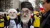 FILE - Two people dressed as Iranian President Hassan Rouhani, left, and Iran's supreme Leader Ayatollah Ali Khamenei, right, participate in an Organization of Iranian-American Communities rally in Washington, March 8, 2019.