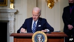 FILE - In this Jan. 27, 2021 photo, President Joe Biden signs an executive order on climate change, at the White House.