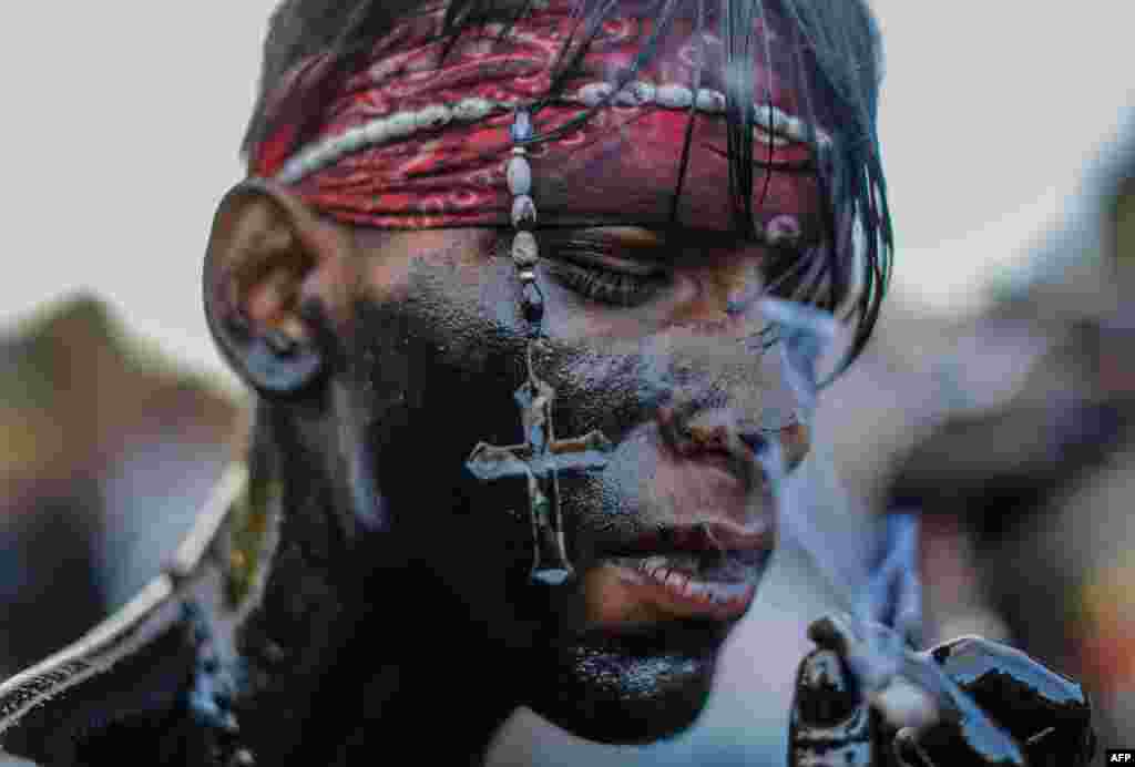 A Catholic faithful smeared in burnt oil, takes part in the opening of the 10-day celebration of the Santo Domingo de Guzman festival in Managua, Nicaragua.