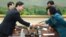 In this photo released by the South Korean Unification Ministry, South Korea's Unification Policy Officer Chun Hae-sung, left, shakes hands with the head of North Korea's delegation Kim Song Hye, right, June 10, 2013.