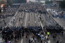 Protesters face off with police during a rally against a controversial extradition law proposal outside the government headquarters in Hong Kong, June 12, 2019.