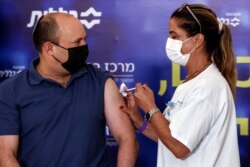 Israeli Prime Minister Naftali Bennett receives a third COVID-19 vaccine, in Kfar Saba, Israel, August 20, 2021.