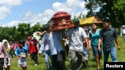 People attend the burial of Olivia Arevalo, an 81-year-old indigenous shaman of the Shipibo-Conibo tribe who was shot dead near her home in Ucayali, in Pucallpa, Peru April 22, 2018. 