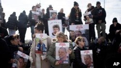 FILE - Families of hostages held by Hamas in the Gaza Strip gather to call out to their loved ones in hopes that the hostages will hear, on loudspeakers at the Gaza border in Kibbutz Nirim, southern Israel, January 11, 2024.