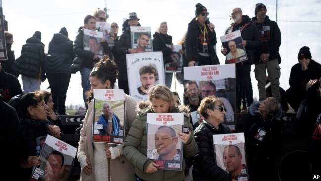 FILE - Families of hostages held by Hamas in the Gaza Strip gather to call out to their loved ones in hopes that the hostages will hear, on loudspeakers at the Gaza border in Kibbutz Nirim, southern Israel, January 11, 2024.