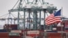 FILE - Chinese shipping containers are stored beside a U.S. flag after they were unloaded at the Port of Los Angeles in Long Beach, California, May 14, 2019. 