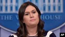 FILE - White House press secretary Sarah Sanders listens to a reporter's question during the daily briefing at the White House in Washington, May 11, 2018. 