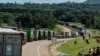 FILE - Trucks wait in a line on the road to enter Uganda in Malaba, a city bordering with Uganda, western Kenya, April 29, 2020. (AFP)