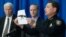 University of Central Florida police Chief Richard Beary, right, shows an example of the assault rifle, along with explosive devices, found in the dorm room of James Oliver Seevakumaran, Monday, Mar. 18, 2013, in Orlando, Fla.