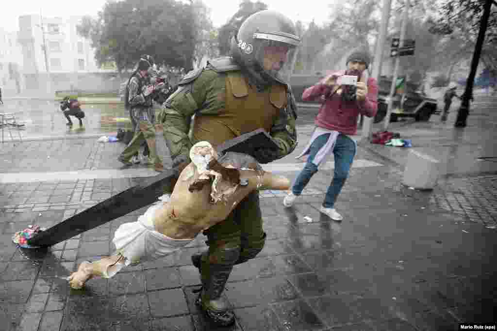 Policemen recover a cross taken from the National Gratitude Church during a protest of students days before a meeting between the Education Minister Adriana Delpiano and the Confederation of Chilean Students in Santiago de Chile, 09 June 2016.