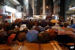 Protesters set up barricades with debris and umbrellas in Hong Kong, Jan. 1, 2020.