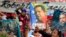 Posters during the annual May Day march in Revolution Square in Havana, Cuba show images of Fidel Castro and Venezuela's late President Hugo Chavez , May 1, 2013. 