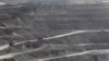 Trucks are seen at a copper mine in Sarlingyi township, Dec. 14, 2012. 