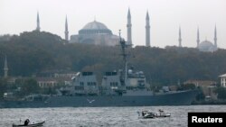 U.S. Navy guided-missile destroyer USS Ross, with the Byzantine-era monument of Hagia Sophia in the background, prepares to leave from the port in Istanbul, Nov. 13, 2014. 