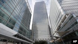 FILE - In this July 28, 2017 photo, is One Canada Square house, center, that hosts the offices of the European Banking Authority EBA, headquarters in London. 