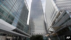 FILE - In this July 28, 2017 photo, is One Canada Square house, center, that hosts the offices of the European Banking Authority EBA, headquarters in London. 