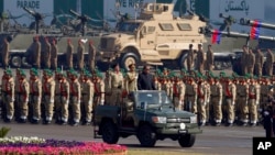 FILE - Pakistan's President Mamnoon Hussain, center on a military vehicle, reviews a military parade to mark Pakistan's Republic Day, in Islamabad, Pakistan, March 23, 2017. 