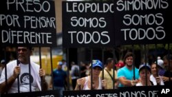 Manifestantes con símbolos que representan una cárcel durante una manifestación a favor del líder opositor Leopoldo López en Caracas.