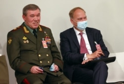 Chief of the General Staff of Russian Armed Forces Valery Gerasimov, left, speaks with Russia's ambassador to the United States before a news conference after the U.S.-Russia summit, in Geneva, Switzerland, June 16, 2021.