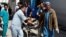 Men transport a victim to a hospital after a blast in Kabul, Afghanistan, March 21, 2018.