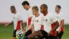 Belgium's captain Vincent Kompany, second right, who is recovering from an injury, keeps a ball up as he takes part in a training session at Estadio Manoel Barradas the day before the World Cup round of 16 soccer match against Belgium, June 30, 2014.