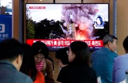 FILE - People watch a TV showing a file image of North Korea's missile launch during a news program at the Seoul Railway Station in Seoul, South Korea, Oct. 2, 2019.