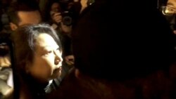 Hong Kong Justice Secretary Teresa Cheng walks as protesters surround her in London, Nov. 14, 2019, in this still image from video obtained via social media.
