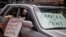 FILE - Protesters with signs calling for rent cancellations drive in a caravan en route to the offices of New York Governor Andrew Cuomo in New York City, May 1, 2020. A moratorium on evictions in the U.S. is due to expire. 