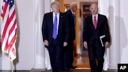  President-elect Donald Trump walks with CKE Restaurants CEO Andy Puzder from Trump National Golf Club Bedminster clubhouse in Bedminster, N.J.