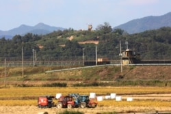 FILE - Military guard posts of North Korea, top, and South Korea, center, in Paju, South Korea, near the border with North Korea, Oct. 15, 2019.