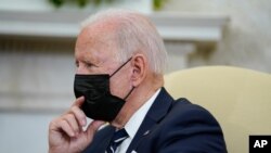 US President Joe Biden listens as he meets with Israeli Prime Minister Naftali Bennett in the Oval Office of the White House, Aug. 27, 2021, in Washington. 