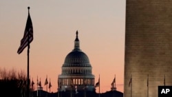 FILE - The U.S. Capitol building, center, and part of the Washington Monument, right, are seen in Washington, Dec. 18, 2019.