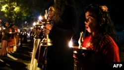 Indian Hindu activists participate in a candlelight vigil outside Kerala State house, as they protest against Kerala government supporting women devotees entering in the Sabarimala Ayyapa temple in the southern state of Kerala, in New Delhi, Dec. 26, 2018