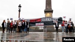 FILE - Reporters Without Borders (RSF) activists demonstrate against restriction on the press in Egypt and to demand the release of detained journalists as part of a two-day visit of Egyptian leader Abdel Fattah al-Sisi in Paris, France, Oct. 24, 2017.