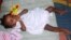 Five-month-old Jessica was taken in by one of the few houses in Nigeria that will care for HIV positive babies. (I. Yakubu/VOA) 