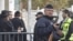 An armed police officer stands guard at the entrance of the Ozar Hatorah Jewish school in Toulouse, southwestern France, March 20, 2012.