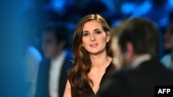 FILE - Marie Portolano, then a Canal+ journalist, gets ready prior to the start of the TV show "Canal Football Club" on March 27, 2016 in Paris. 