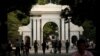 People walk near the gate of Tsinghua University in Beijing, China, July 27, 2016.