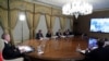 Turkish President Recep Tayyip Erdogan, left, flanked by his ministers and advisors participates in a teleconference with European leaders, in Istanbul, March 17, 2020.