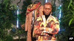 Wale Oyejide, founder of the brand Ikire Jones, stands with his menswear design for a fashion collection inspired by the superhero film “Black Panther,” Feb. 12, 2018, in New York. 