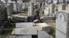 Rabbi Joshua Bolton of the University of Pennsylvania's Hillel center surveys damaged headstones at Mount Carmel Cemetery, Feb. 27, 2017, in Philadelphia.