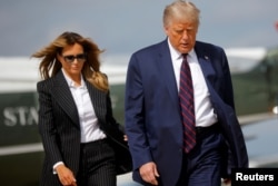 U.S. President Donald Trump and first lady Melania Trump board Air Force One as they depart Washington on campaign travel to participate in the first presidential debate with Democratic presidential nominee Joe Biden in Cleveland, Ohio.