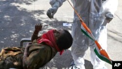 A health worker takes a swab sample to test for COVID-19 in Hyderabad, India, Jan. 29, 2022.