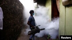 FILE - A health worker fumigates against mosquitoes in a residential area, as Sri Lanka tries to curb dengue fever across the island in Colombo, Sri Lanka July 12, 2023. 