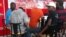 Not just a game any more … Punters discuss possible results as they follow games on TV in a sports shop. (Photo: Taurai Shava)