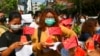 FILE - Anti-coup protesters place defaced Chinese flags on watermelon, April 13, 2021, in Yangon, Myanmar. The group opposed trade with China, saying it affected local prices. Analysts today say Beijing's perceived support for Myanmar's junta has frustrated many.